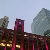 Britanica building lit up at sunset.