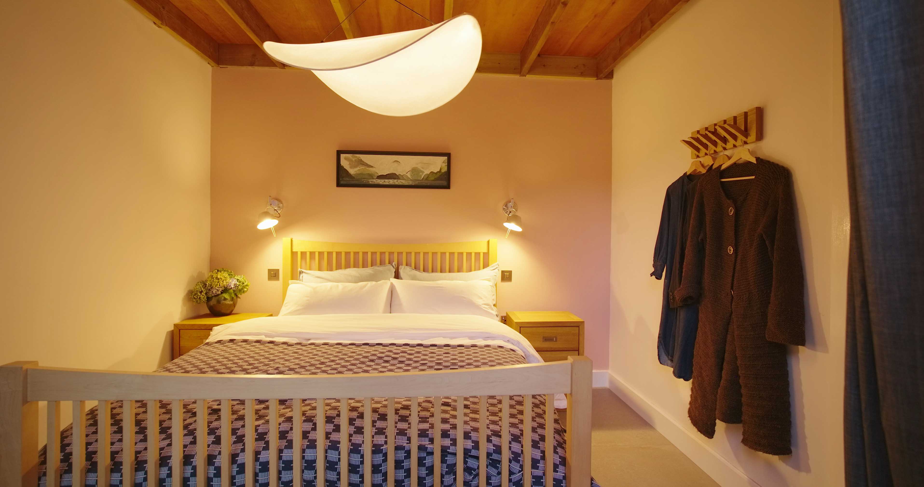 Gently lighting for a warm, cosy ground floor bedroom with king size bed at Fernleigh Courtyard luxury holiday cottage.
